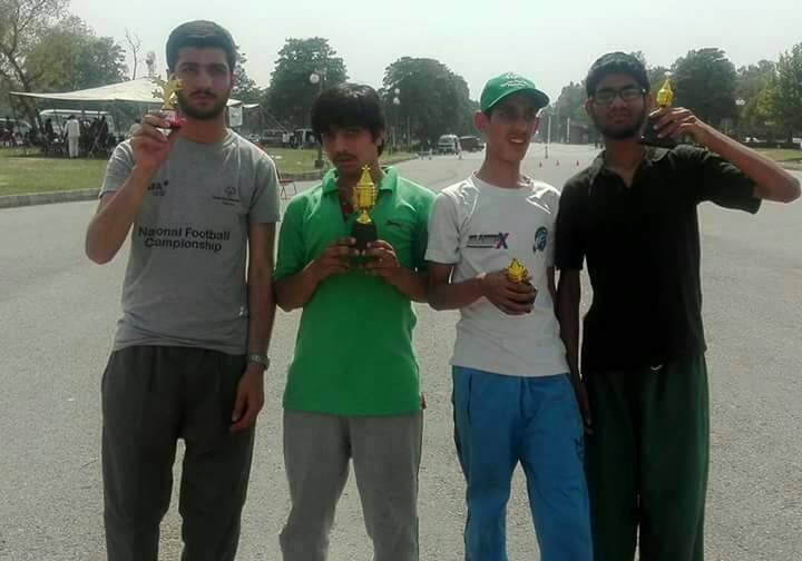 Members of the community holding trophies